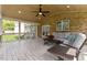 Relaxing sunroom features brick wall, ceiling fan, tile floors and comfortable seating area at 9603 Clubvalley Way, Raleigh, NC 27617