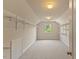 Spacious walk-in closet with custom shelving and natural light from window at 9603 Clubvalley Way, Raleigh, NC 27617