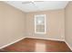 Neutral bedroom featuring hardwood floors, light-colored walls, and a bright window at 100 Wentbridge Rd, Cary, NC 27519
