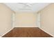 Bonus room with ceiling fan, neutral walls, two doors and wood floors at 100 Wentbridge Rd, Cary, NC 27519