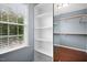 Walk-in closet showcases custom shelving and ample storage space, complemented by hardwood floors at 100 Wentbridge Rd, Cary, NC 27519