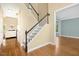 Open entryway showcasing hardwood floors, staircase with black banister, and views into adjacent rooms at 100 Wentbridge Rd, Cary, NC 27519