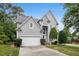 Inviting two-story home with lush landscaping, a two-car garage, and a charming front entrance at 100 Wentbridge Rd, Cary, NC 27519