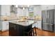 Modern kitchen with a center island, stainless steel appliances, granite countertops, and ample cabinet space at 100 Wentbridge Rd, Cary, NC 27519