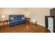 Comfortable living room with a blue sofa, side tables, and hardwood floors at 100 Wentbridge Rd, Cary, NC 27519