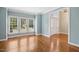 Bright living room with hardwood floors, large windows, and a view of the entryway at 100 Wentbridge Rd, Cary, NC 27519