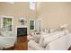 Bright living room with a fireplace, large windows, hardwood floors, and comfortable seating at 100 Wentbridge Rd, Cary, NC 27519