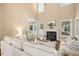 Cozy living room with fireplace, hardwood floors, comfortable seating, and plenty of natural light at 100 Wentbridge Rd, Cary, NC 27519