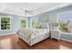 Serene main bedroom with tray ceilings, ceiling fan, and natural light from surrounding windows at 100 Wentbridge Rd, Cary, NC 27519