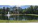 Scenic community pond with a beautiful fountain, walking path and lush green surroundings at 100 Wentbridge Rd, Cary, NC 27519