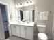 Well-lit bathroom featuring a double sink vanity, large mirror, and modern fixtures at 1024 Holland Bend Dr Dr, Cary, NC 27519