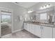 Bright bathroom showcasing dual vanities, granite counters, and a large mirror at 1024 Holland Bend Dr Dr, Cary, NC 27519
