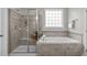 Well-lit bathroom featuring a tiled shower, separate bathtub, and neutral decor at 1024 Holland Bend Dr Dr, Cary, NC 27519
