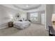 Bright bedroom featuring a tray ceiling, ceiling fan, and large window at 1024 Holland Bend Dr Dr, Cary, NC 27519
