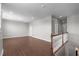 Spacious bonus room featuring hardwood floors and staircase with white railings at 1024 Holland Bend Dr Dr, Cary, NC 27519