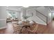 Bright dining area with a round wooden table, four chairs, and stairs in the background at 1024 Holland Bend Dr Dr, Cary, NC 27519