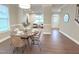 Open-concept dining room with wood floors and seating for four at 1024 Holland Bend Dr Dr, Cary, NC 27519