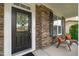 Close-up of the front door showcasing its decorative glass and covered porch with seating at 1024 Holland Bend Dr Dr, Cary, NC 27519