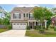 Charming two-story home featuring a stone facade, neutral siding, and a well-manicured front yard at 1024 Holland Bend Dr Dr, Cary, NC 27519