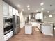 Well-lit kitchen featuring stainless steel appliances, white cabinetry, and granite countertops at 1024 Holland Bend Dr Dr, Cary, NC 27519