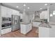 Bright kitchen featuring stainless steel appliances, granite countertops, and white cabinets at 1024 Holland Bend Dr Dr, Cary, NC 27519