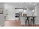 Modern kitchen with stainless steel appliances, breakfast bar, and white cabinetry at 1024 Holland Bend Dr Dr, Cary, NC 27519