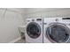 Functional laundry room with modern washer and dryer units and storage shelves at 1024 Holland Bend Dr Dr, Cary, NC 27519