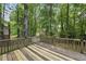 A charming back deck features a beautiful natural wooded landscape and views at 103 Oxford Cir, Knightdale, NC 27545