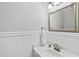 Bathroom featuring white walls and vanity with mirror and chrome fixtures at 103 Oxford Cir, Knightdale, NC 27545