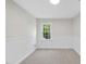 Bright bedroom with carpet flooring, chair railing on walls and a window providing natural light and green outdoor views at 103 Oxford Cir, Knightdale, NC 27545