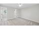 Neutral bedroom with carpeted floor, ceiling fan, window, and adjoining bath and closet at 103 Oxford Cir, Knightdale, NC 27545