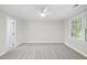 Spacious bedroom features neutral carpet, a ceiling fan and bright natural light from a window at 103 Oxford Cir, Knightdale, NC 27545