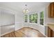Bright breakfast nook featuring hardwood floors and large windows with views of the backyard at 103 Oxford Cir, Knightdale, NC 27545
