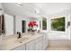 Bright bathroom with double sink vanity, tile flooring, garden tub and large windows at 104 S Crabtree Knl, Chapel Hill, NC 27514