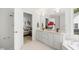 Bathroom with double sink vanity and soaking tub in the background and view to the bedroom at 104 S Crabtree Knl, Chapel Hill, NC 27514