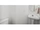 Half bathroom with a modern pedestal sink and light-colored walls at 104 S Crabtree Knl, Chapel Hill, NC 27514