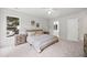 Bright bedroom with neutral tones and decor with an ensuite bathroom and natural light from windows at 104 S Crabtree Knl, Chapel Hill, NC 27514