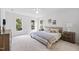 Bright bedroom featuring neutral decor, side tables, and windows overlooking outside nature at 104 S Crabtree Knl, Chapel Hill, NC 27514
