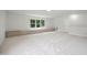 Large bonus room with neutral carpet, natural light and a cozy window seat at 104 S Crabtree Knl, Chapel Hill, NC 27514