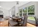 Inviting dining room filled with natural light, featuring hardwood floors, comfortable seating, and seamless connection to other living areas at 104 S Crabtree Knl, Chapel Hill, NC 27514