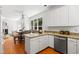 Open-concept kitchen and dining area featuring white cabinets, granite countertops, stainless steel appliances, and hardwood flooring at 104 S Crabtree Knl, Chapel Hill, NC 27514