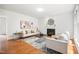 Bright living room with hardwood floors, fireplace, two sofas, and lots of natural light at 104 S Crabtree Knl, Chapel Hill, NC 27514