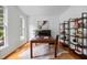 Cozy office space with hardwood floors, built in shelving, a large window, and a dark wood desk at 104 S Crabtree Knl, Chapel Hill, NC 27514