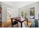 Cozy office space with hardwood floors, a large window, and a dark wood desk with chair at 104 S Crabtree Knl, Chapel Hill, NC 27514