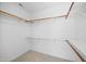 Walk-in closet with shelves and carpeted floor with wooden rods for hanging clothes at 104 S Crabtree Knl, Chapel Hill, NC 27514