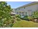 The exterior of the home showcases a screened porch, patio, and landscaped yard with lush plants and a cozy bench at 1056 Evening Shade Ave, Rolesville, NC 27571