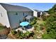 Aerial view of the backyard showcasing the home, patio area, and landscaped yard at 1056 Evening Shade Ave, Rolesville, NC 27571