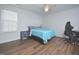 Bedroom with wood flooring, blue bedding, and natural light at 1056 Evening Shade Ave, Rolesville, NC 27571