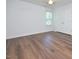 Bedroom with wood flooring, a ceiling fan, and large windows for natural light at 1056 Evening Shade Ave, Rolesville, NC 27571