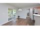 A casual dining area featuring sliding glass doors leading to the deck, wood floors, and modern lighting at 1056 Evening Shade Ave, Rolesville, NC 27571